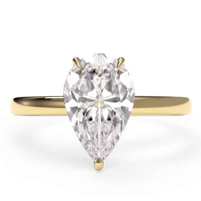 birds eye view of a pear cut diamond solitiare engagement ring in yellow gold metal
